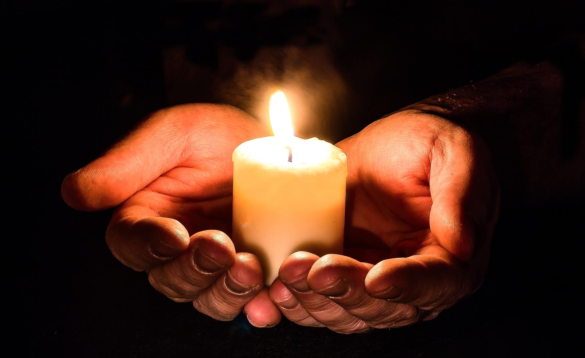 holding a burning candle