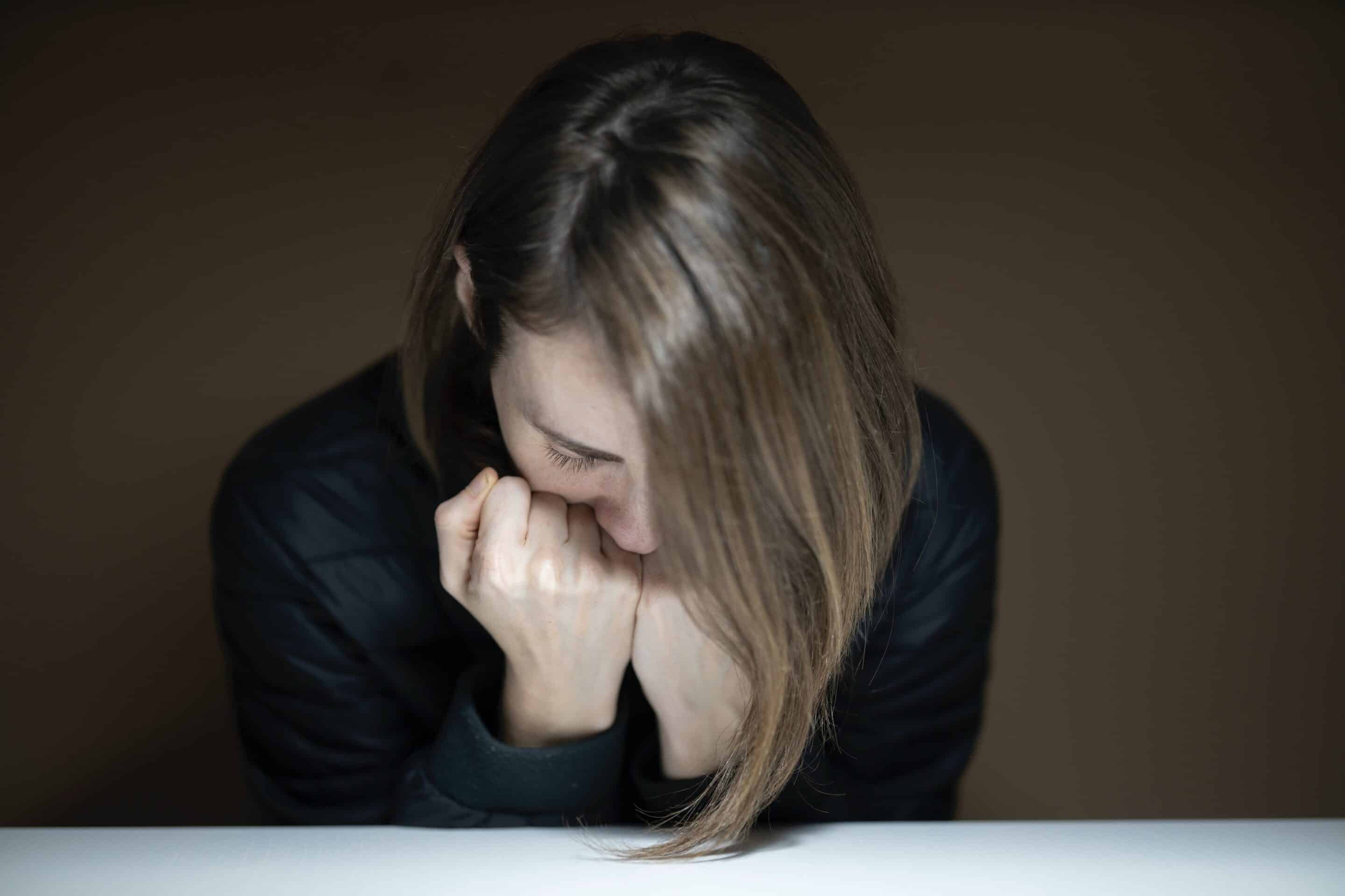 Woman hunched over in depression