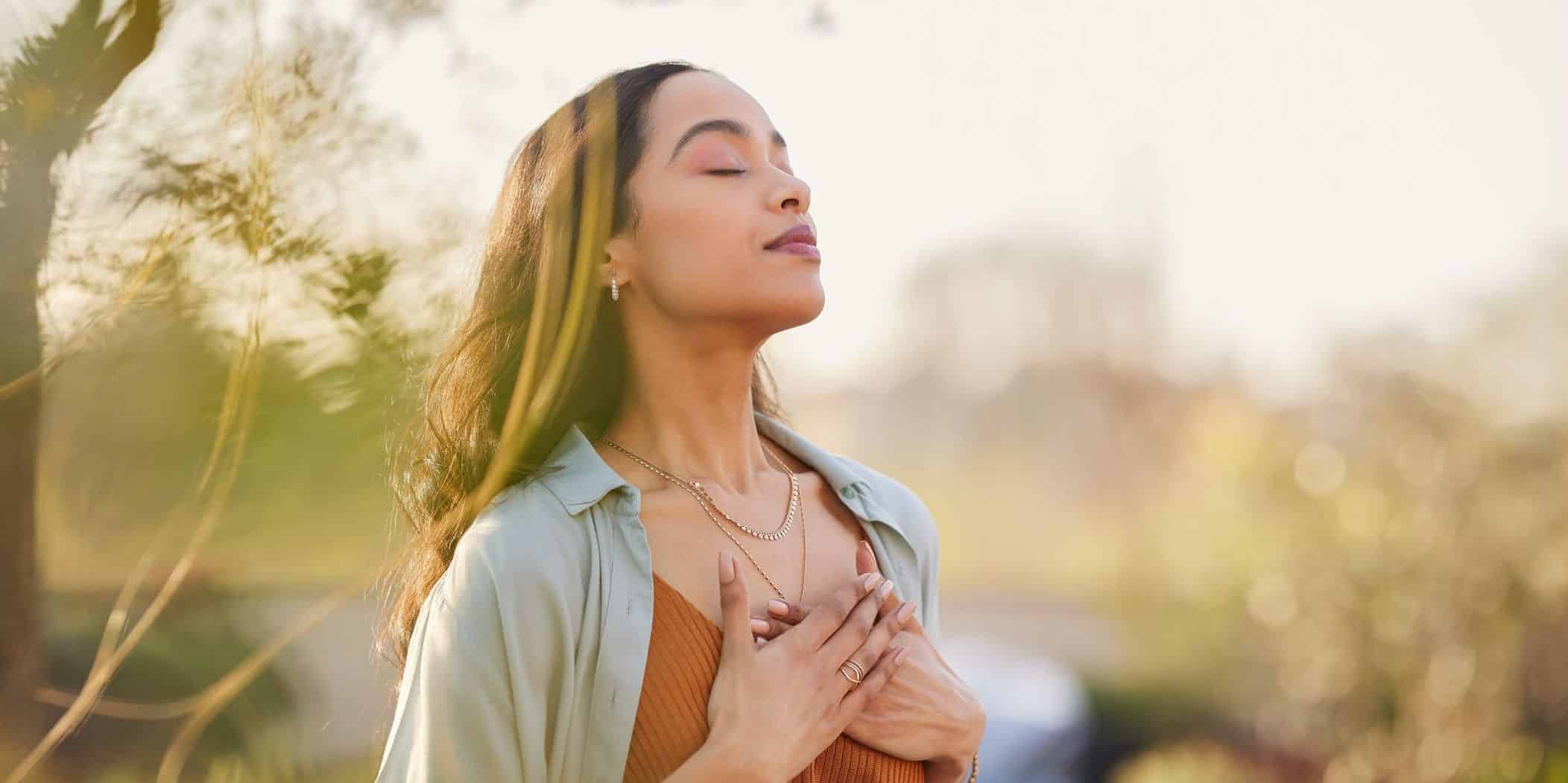 woman inhaling deeply in field - 11th step prayer