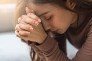 Woman praying for her alcoholic husband