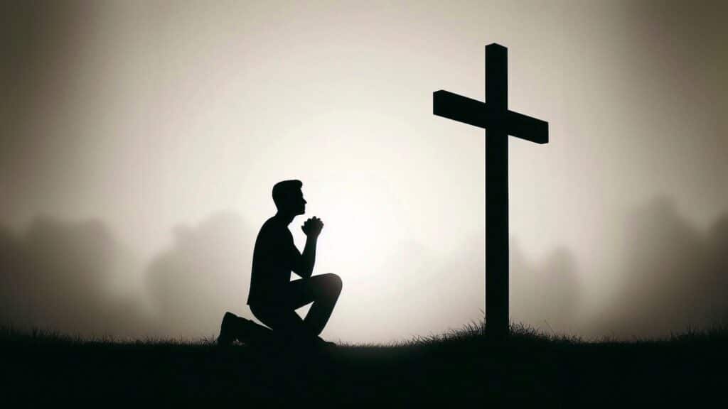 Image of a man kneeling before the cross, praying